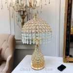 Luxury Gold Metal Table Lamp with crystal hanging shade, perfect for an elegant home decor setting.