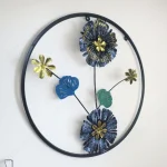 Modern Blue and Black Metal Wall Art in a circular frame hanging on a white wall for living room decor.
