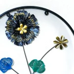 Close-up of the Blue and Black Metal Flower and shiny gold center detail on the round wall hanging.