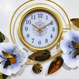 Close-up of the Premium gold clock face and white flowers with butterfly accents.
