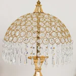 Close-up of the best quality crystal dome shade and hanging drops on the Premium Gold Table Lamp.