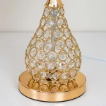 Detailed view of the Luxury gold metal base and the crystal-covered teardrop body of the Premium Quality Lamp.