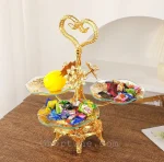Beautiful gold 3-tier serving stand on a wooden table, holding colorful candy, showing it being used as a luxury candy dish.