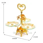 Detailed close-up of the fancy gold base and carved legs of a luxury gold serving stand.