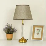 Premium golden metal bedside lamp with clear crystal pillar and fabric shade